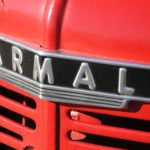 photo of the grill of an old red McCormick Farmall tractore