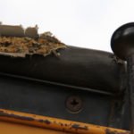 photo of torn armrest on an old yellow bulldozer