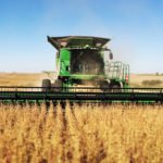 John Deere combine harvesting soy beans in an Iowa field
